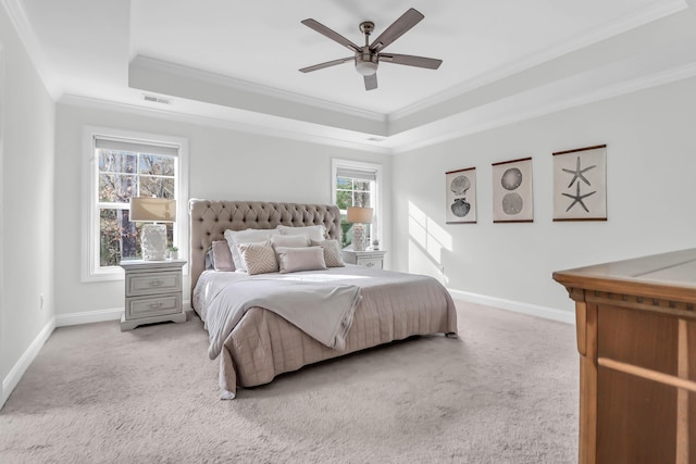 carpeted bedroom featuring ceiling fan, a raised ceiling, and crown molding