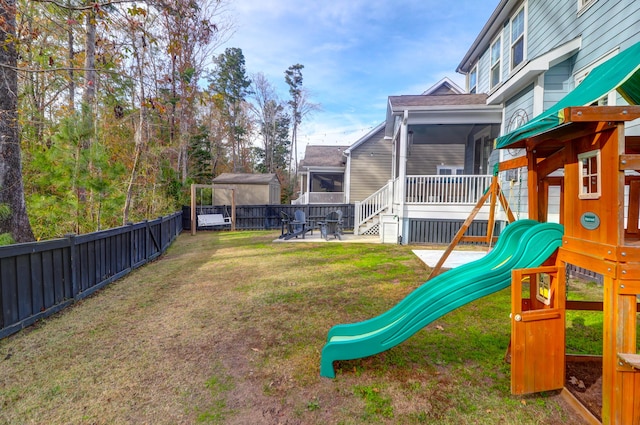 view of yard featuring a sunroom, a playground, and a patio