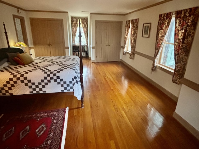 bedroom with hardwood / wood-style flooring and crown molding