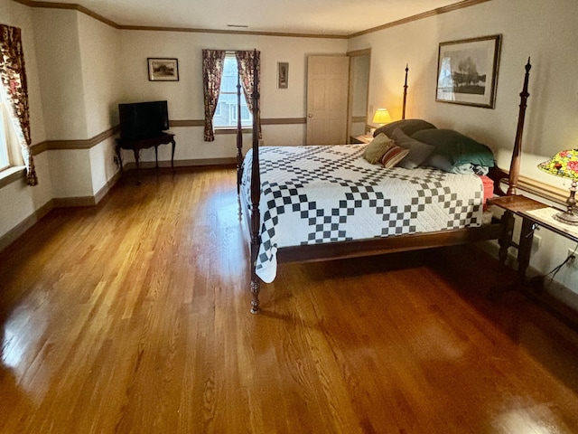 unfurnished bedroom featuring wood-type flooring and ornamental molding