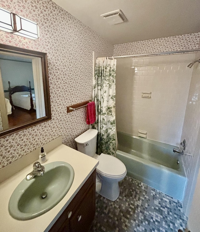 full bathroom with vanity, shower / tub combo, and toilet