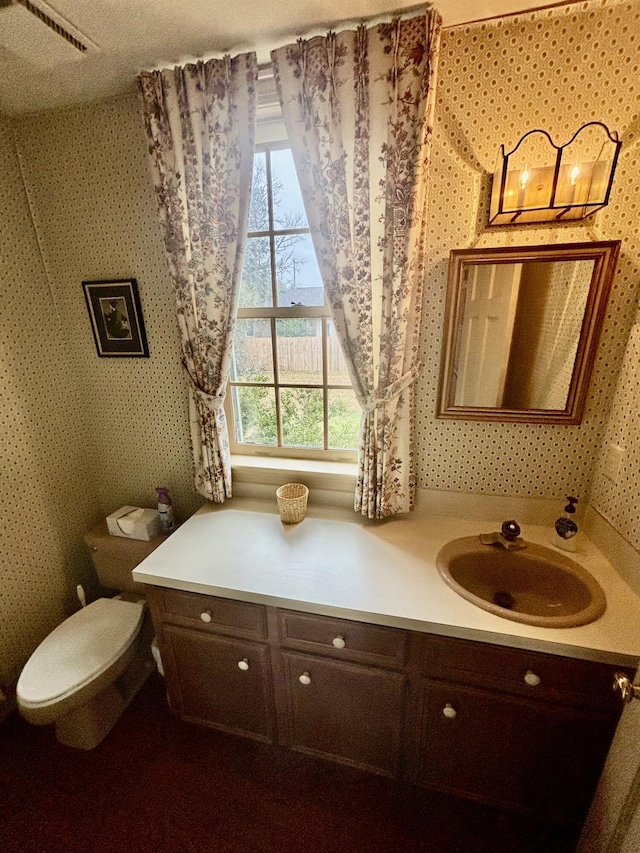 bathroom featuring vanity and toilet