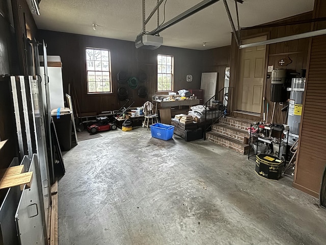 garage with wood walls and a garage door opener