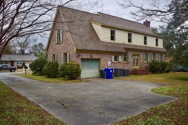 view of front of house featuring central AC unit and a garage