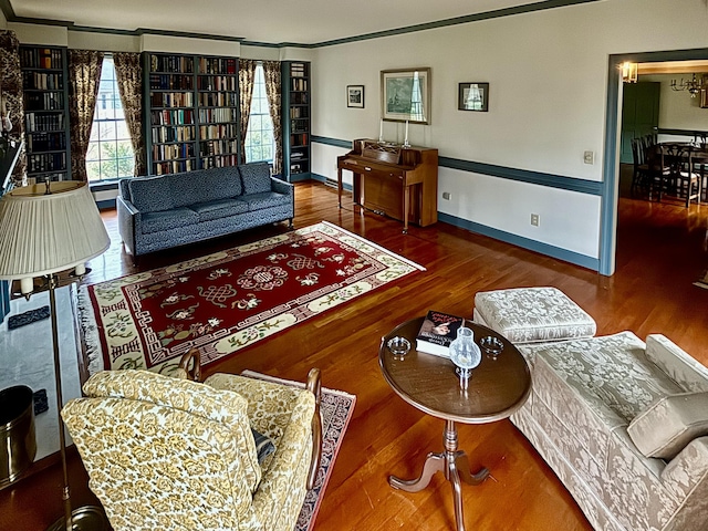 living room with dark hardwood / wood-style flooring and crown molding