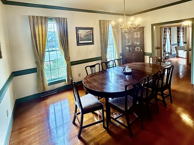 dining space with a notable chandelier and wood-type flooring