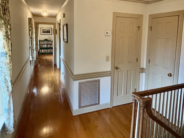 hall with dark hardwood / wood-style flooring and ornamental molding