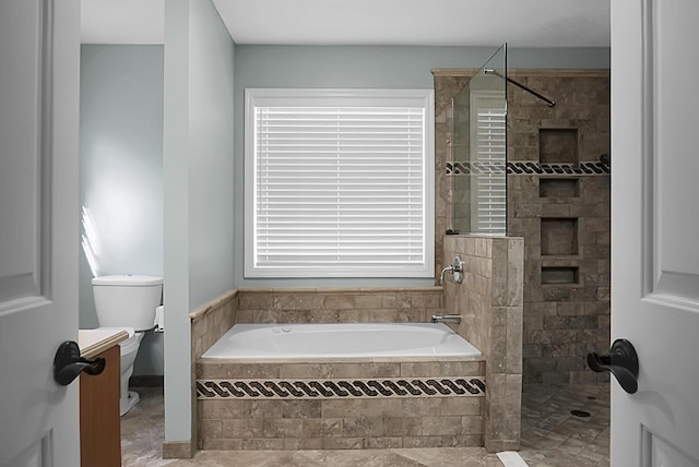 bathroom featuring a healthy amount of sunlight, shower with separate bathtub, and toilet
