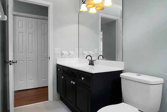 bathroom with tile patterned flooring, vanity, and toilet