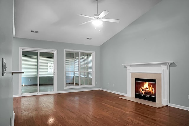 unfurnished living room featuring ceiling fan, a fireplace, vaulted ceiling, and hardwood / wood-style flooring