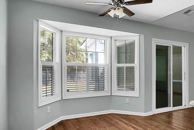 empty room featuring ceiling fan and wood-type flooring