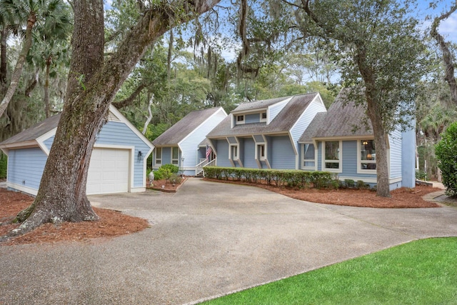 view of front of home featuring an outbuilding and roof with shingles