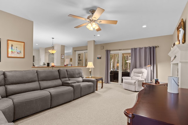 carpeted living room featuring ceiling fan