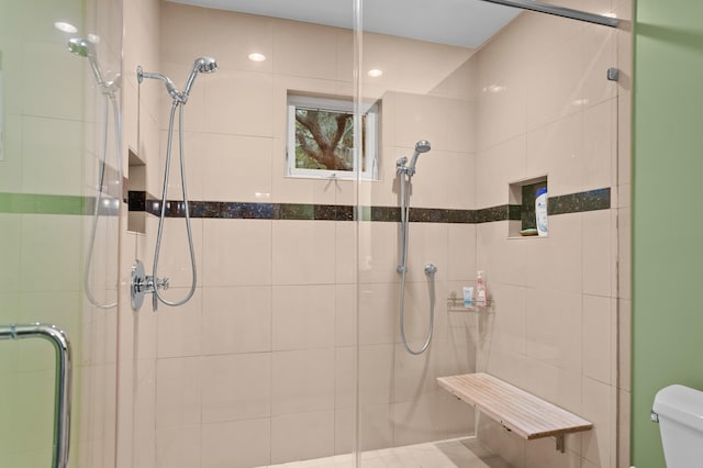 bathroom with walk in shower and toilet