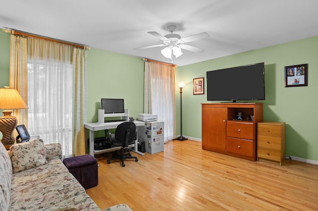 office featuring light hardwood / wood-style floors and ceiling fan