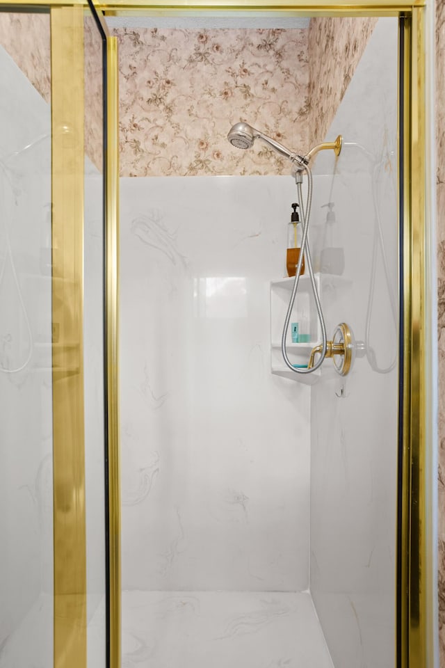 bathroom featuring a shower with door