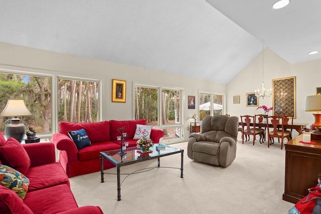 carpeted living room with an inviting chandelier and lofted ceiling