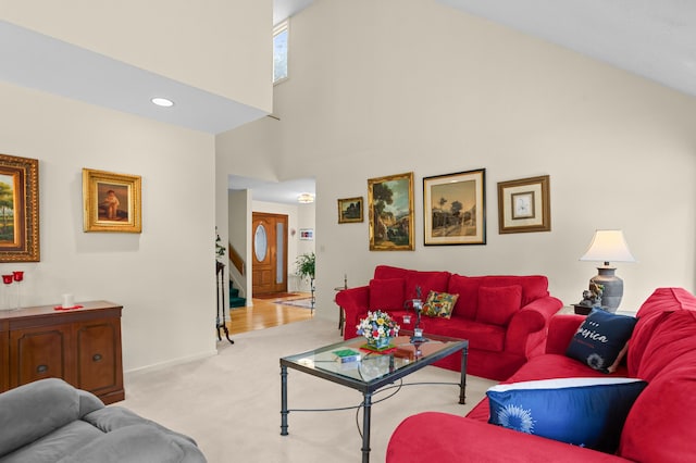 carpeted living room with a high ceiling