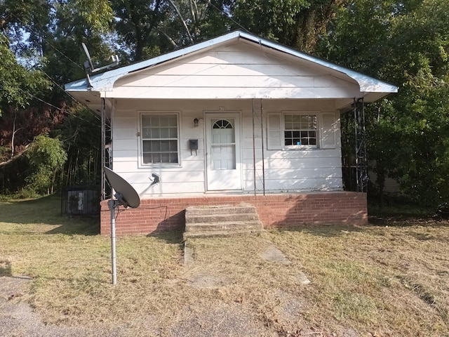 bungalow-style house featuring a front yard