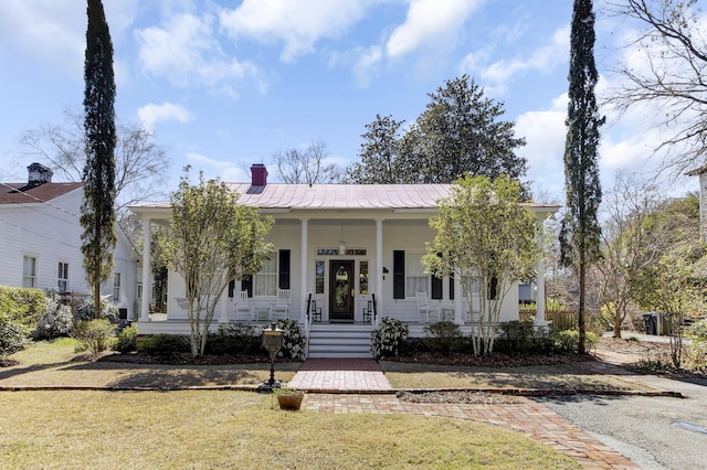 214 E Doty Ave, Summerville, SC 29483 - view of front of home with a front lawn, a chimney, covered porch, and metal roof