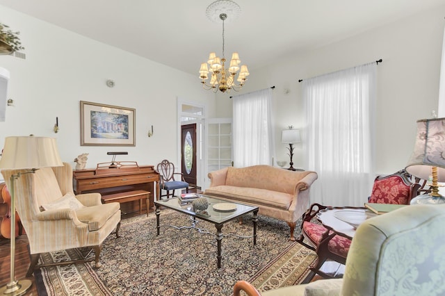 living room featuring a notable chandelier, wood finished floors, and visible vents