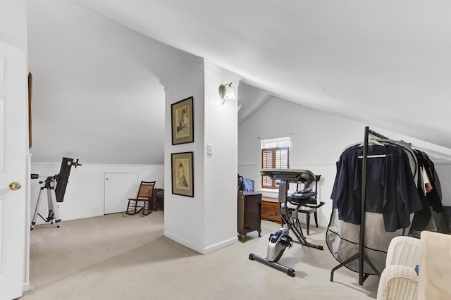 exercise room with baseboards, lofted ceiling, and carpet floors