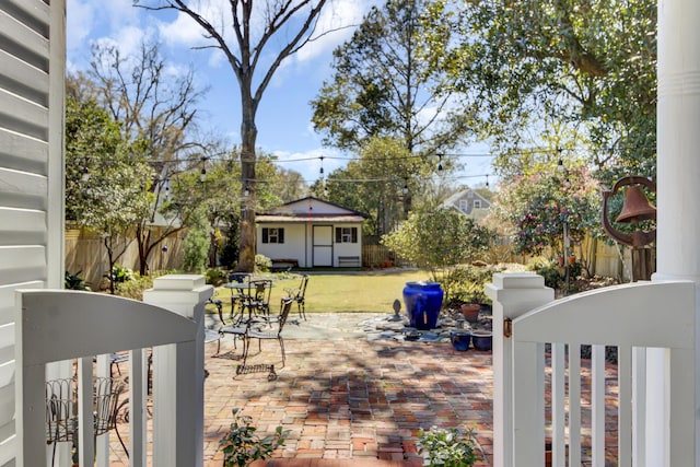 view of patio / terrace with fence private yard and an outdoor structure