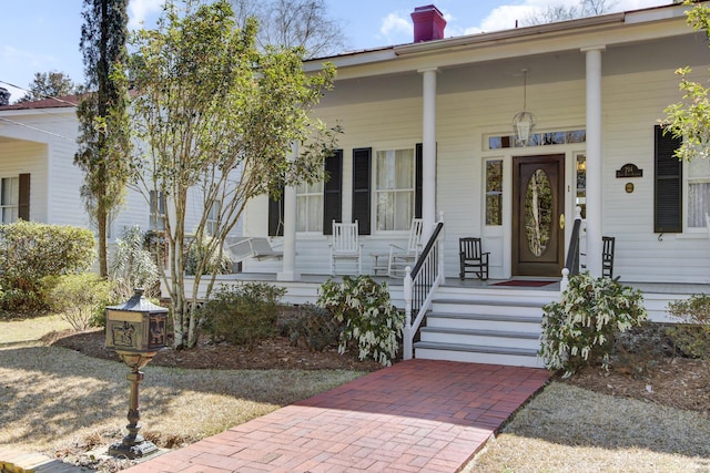 view of front of property featuring a porch and a chimney