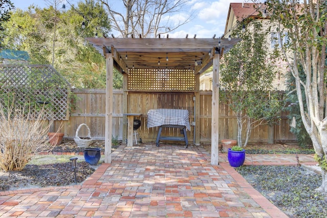 view of patio with a pergola and fence