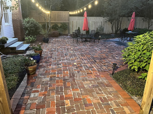 view of patio featuring fence