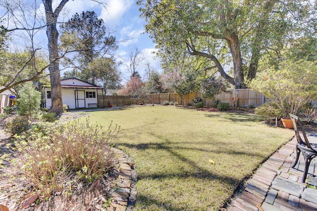 view of yard with an outdoor structure and fence