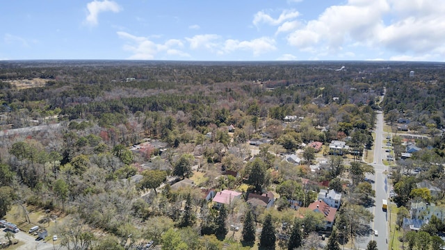 birds eye view of property with a forest view