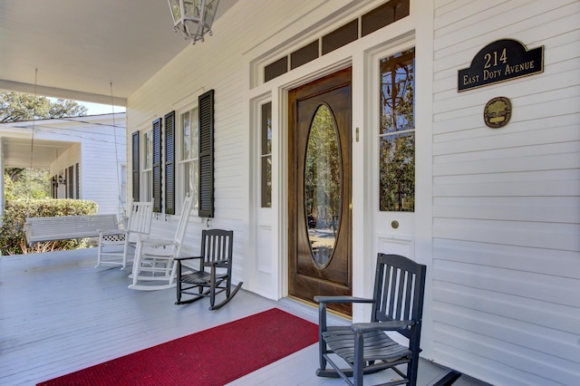 view of exterior entry with covered porch