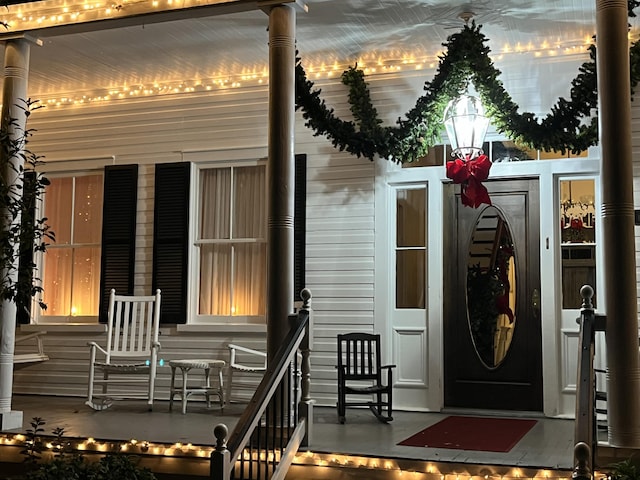 view of exterior entry with a porch