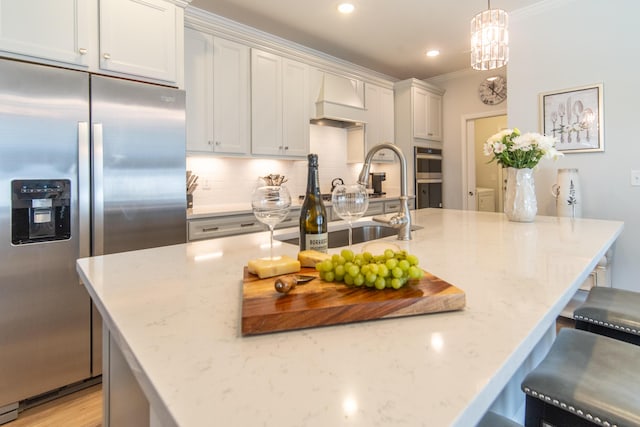 754 Blue Iris Way, Summerville, SC 29486 - kitchen featuring appliances with stainless steel finishes, custom range hood, ornamental molding, backsplash, and light stone counters