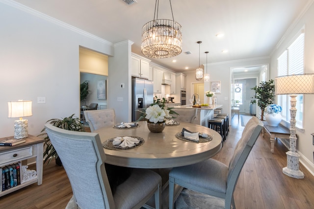 754 Blue Iris Way, Summerville, SC 29486 - dining room with wood finished floors, a chandelier, recessed lighting, and crown molding