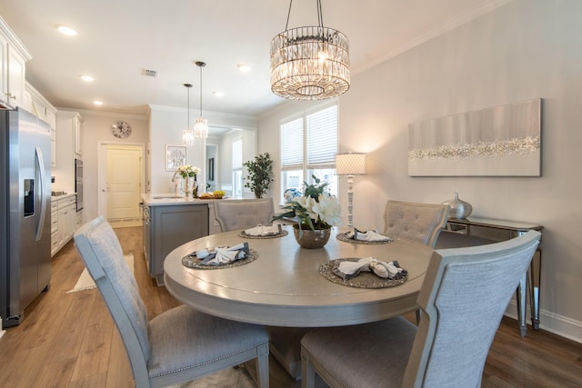 754 Blue Iris Way, Summerville, SC 29486 - dining space with a chandelier, wood finished floors, crown molding, and recessed lighting