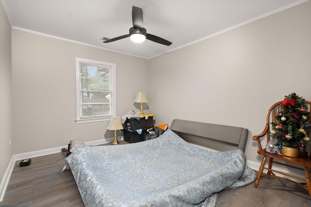 bedroom featuring hardwood / wood-style flooring, ornamental molding, and ceiling fan