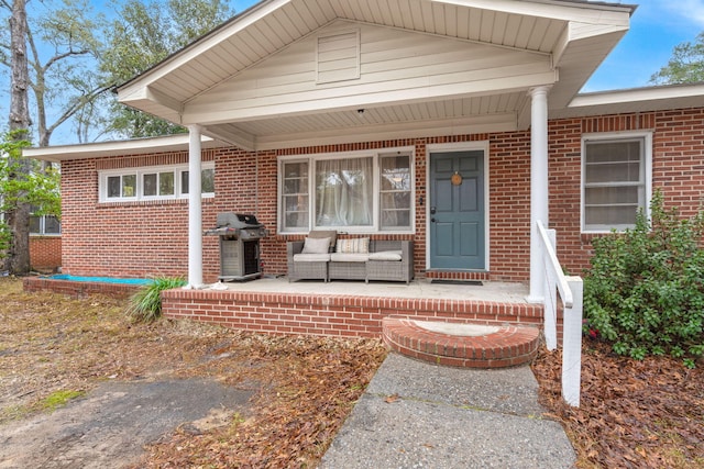 view of exterior entry with covered porch