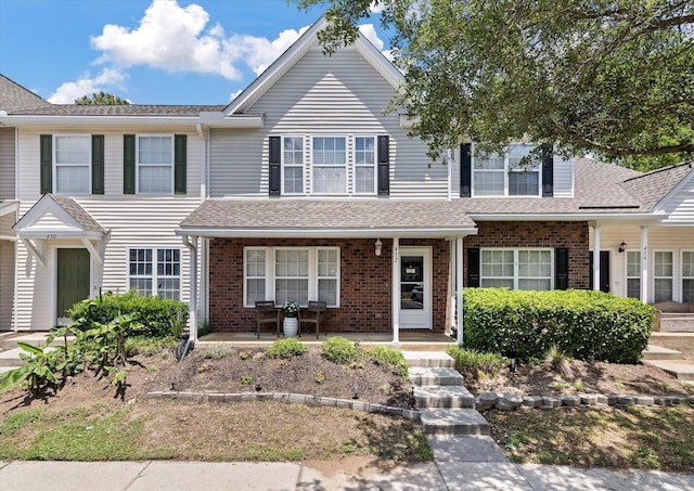 432 Doane Way, Wando, SC 29492 - view of front of home with a porch, brick siding, and roof with shingles
