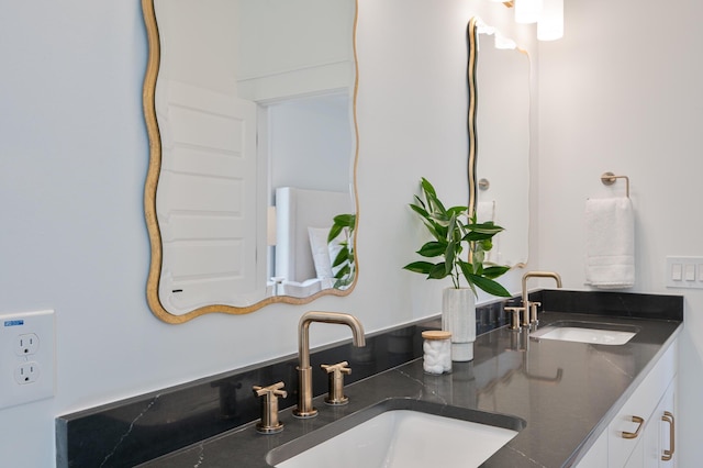 bathroom with a sink and double vanity