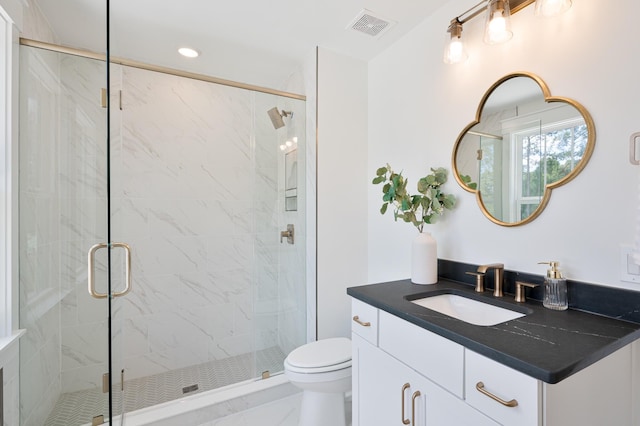 bathroom with toilet, vanity, visible vents, marble finish floor, and a shower stall