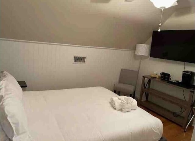 104 Legend Oaks Way, Summerville, SC 29485 - bedroom with a wainscoted wall, wood finished floors, and visible vents