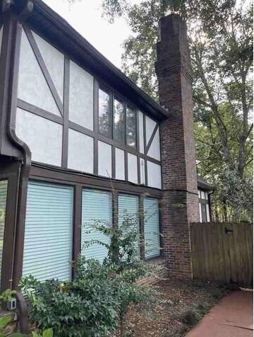 104 Legend Oaks Way, Summerville, SC 29485 - view of home's exterior featuring fence, a chimney, and stucco siding