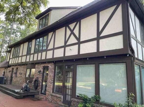 property entrance featuring brick siding and stucco siding