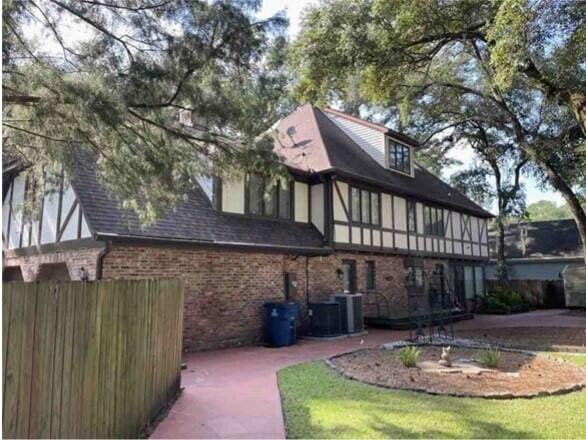 104 Legend Oaks Way, Summerville, SC 29485 - exterior space featuring brick siding, a shingled roof, fence, central AC, and stucco siding
