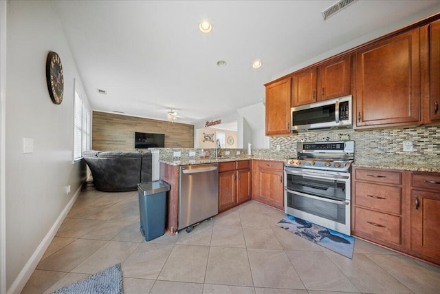 kitchen featuring tasteful backsplash, a ceiling fan, visible vents, and appliances with stainless steel finishes