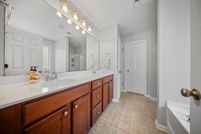 bathroom with tile patterned flooring, double vanity, visible vents, and a sink