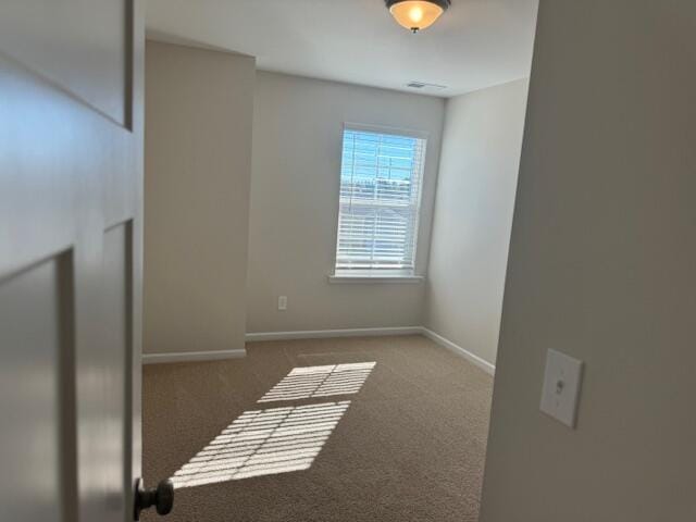 unfurnished room featuring dark carpet