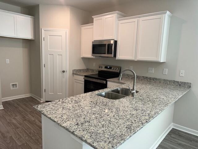 kitchen featuring white cabinets, sink, stainless steel appliances, and dark wood-type flooring